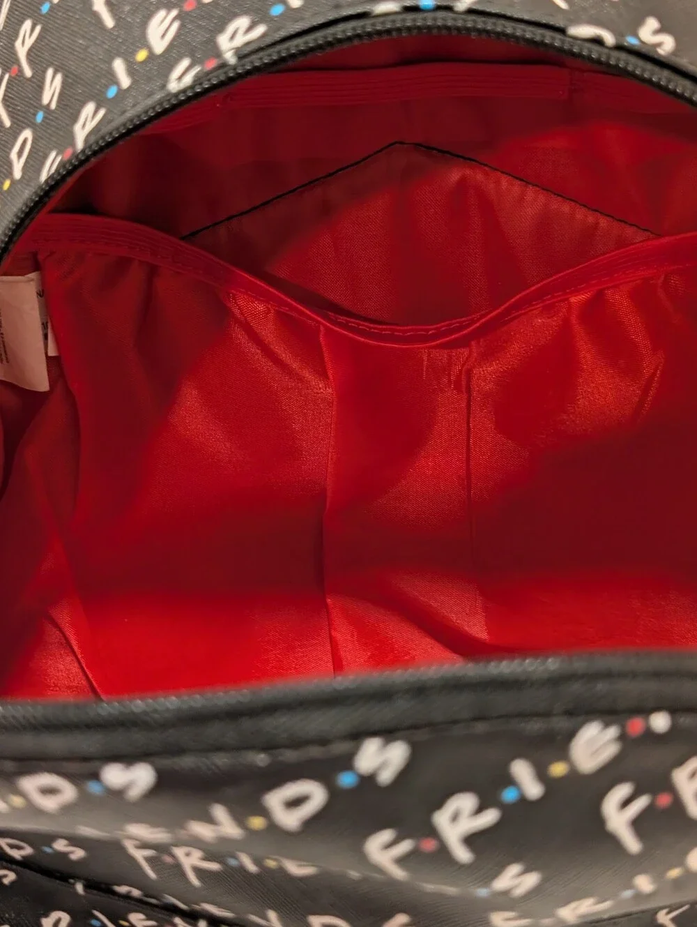 Friends Backpack all over print. need small repair see zoomed in photo
