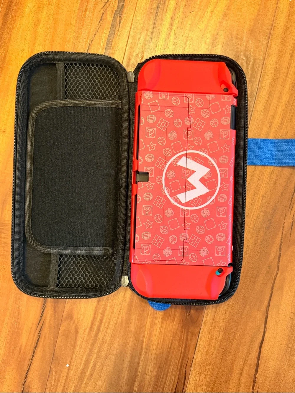 Nintendo Red Handheld Console with Blue Thumb Grips