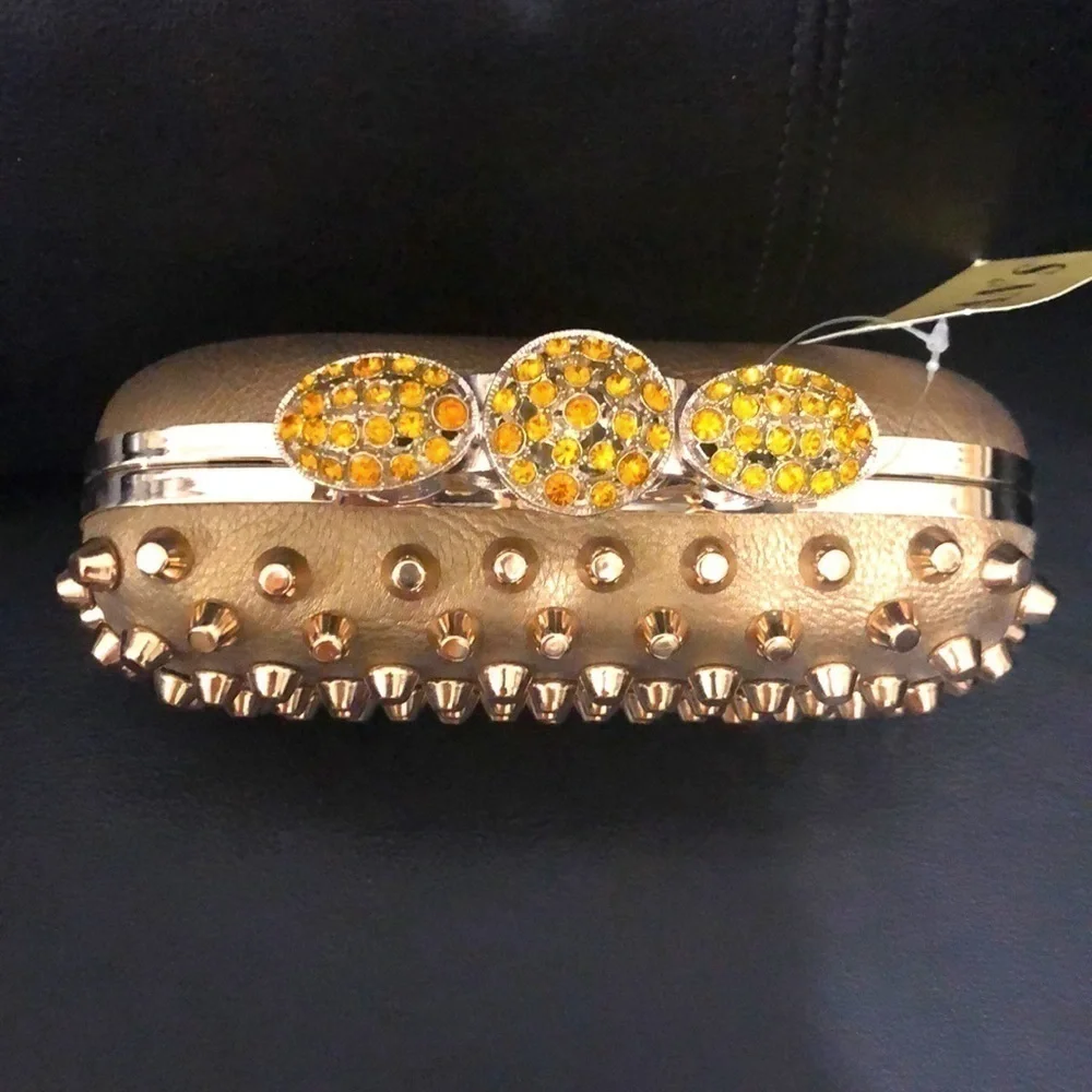 Skulls knuckles ring handles, rhinestone spikes studded clutch.