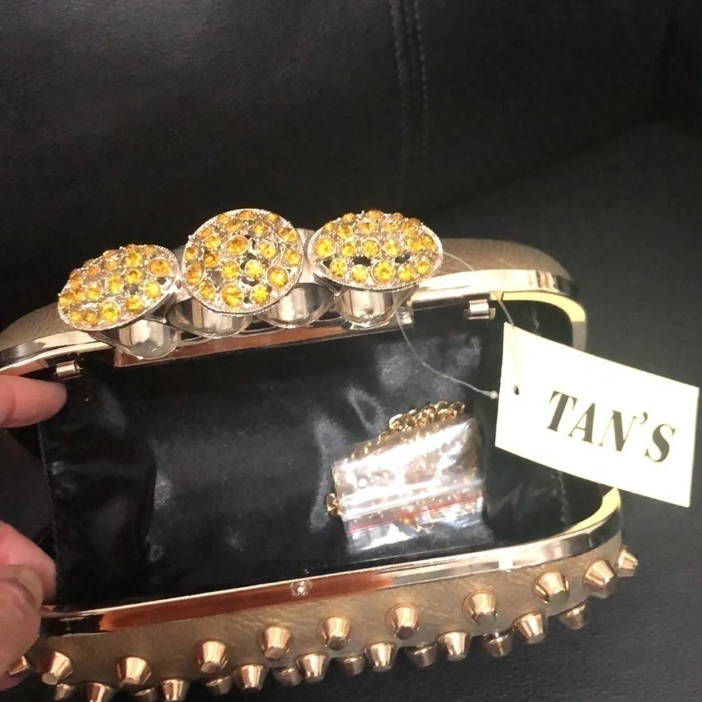Skulls knuckles ring handles, rhinestone spikes studded clutch.