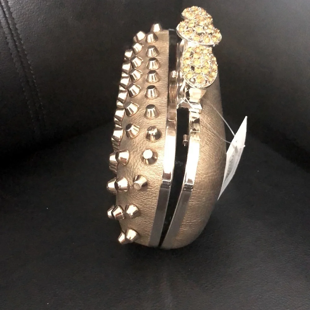 Skulls knuckles ring handles, rhinestone spikes studded clutch.
