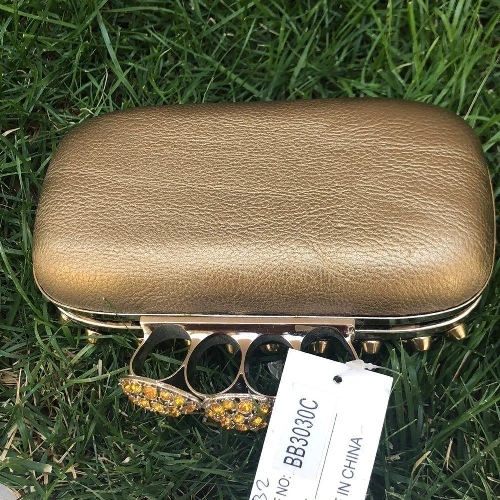 Skulls knuckles ring handles, rhinestone spikes studded clutch.