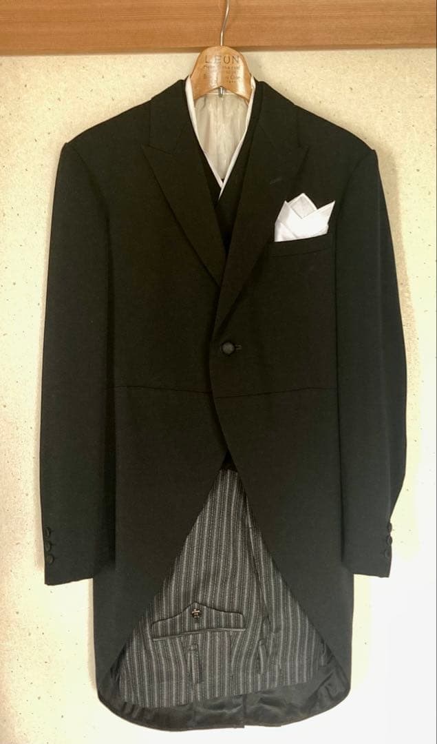 Black tailcoat morning coat with tie, gloves, and handkerchief