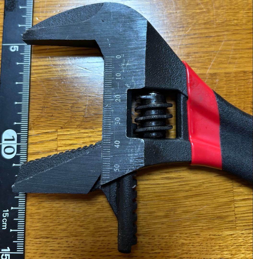 Adjustable wrench with scale, made of steel